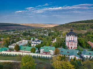 Flight over a christian monastery surrounded by autumn forest. Kurky monastery, Moldova republic of. © Igor Syrbu