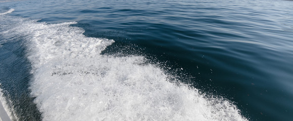 The trail of a motorboat on the sea