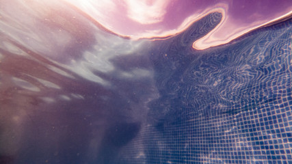 View from underwater on a swimming pool with a calm surface