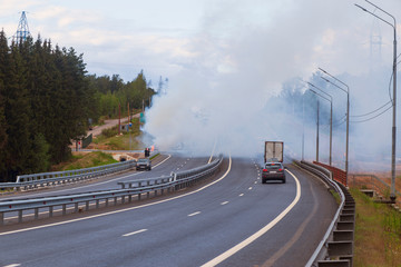 car accident with a burning car and smoke