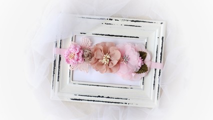 Headband flower with pastel color made out of flower fabric on vintage photo frame. The handmade floral is great for hair accessories with its colorful flower and beautiful for hair band.