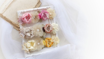 Headband flower with pastel color made out of flower fabric on white photo frame. The handmade floral is great for hair accessories with its colorful flower and beautiful for hair band.