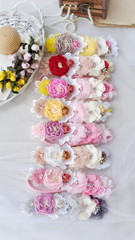 Obraz na płótnie Canvas Headband flower made out of flower fabric in beautiful pastel colors. The handmade floral is great for hair accessories with its colorful flower and beautiful for hair band.