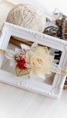 Fototapeta na wymiar Headband flower with pastel color made out of flower fabric on a white photo frame. The handmade floral is great for hair accessories with its colorful flower and beautiful for hair band.