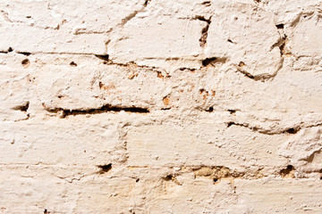 The texture of a brick wall painted with white paint.