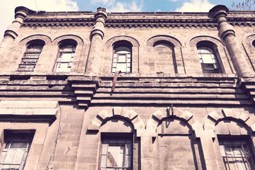 Landscape with an abandoned, collapsing building in the city
