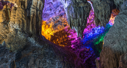 Close-up view of colorful natural stalactites inside cave