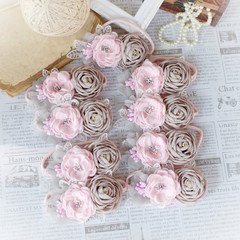 Handmade flower as headband hair accessory made out of fabric flowers in beautiful soft pink and gray colors