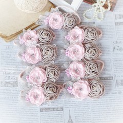 Handmade flower headband hair accessory made out of fabric flowers in beautiful soft pink and gray colors