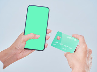 Woman with smartphone and credit card