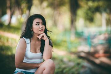 Fototapeta premium Beautiful thai woman very sad from unrequited love,She rethink and think over about love,vintage style,dark tone,broken heart,asian girl think a lot because she fat