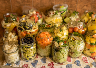 glass jars with various vegetables, salting various vegetables in glass jars for long-term storage, variety fermented green vegetables