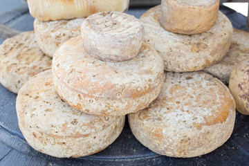 French Comte cheese wheel crusts aging for months