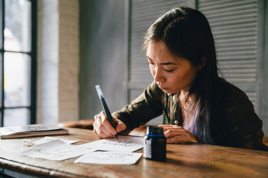 Young asian woman practicing lettering