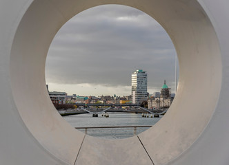 Fototapeta na wymiar A view of Dublin, Ireland framed by an aperture in a bridge over the River Liffey