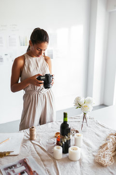 Ethnic photographer checking pictures during event planning