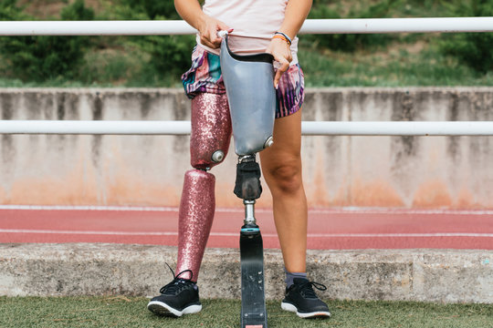 woman putting on artificial leg