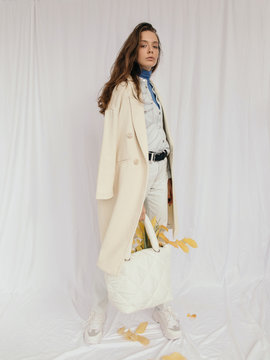 Stylish woman with bag of autumn leaves