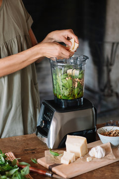 Chef cooking pesto sauce in blender