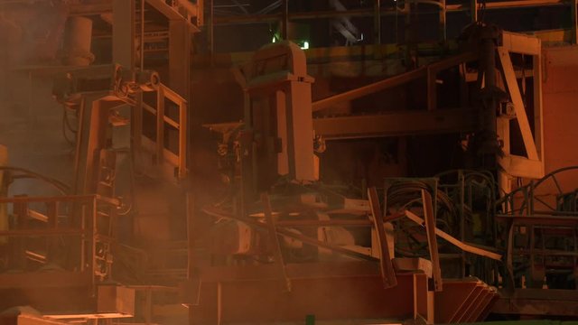 Red hot steel metal billets after molten steel casting. Continuous casting machine. Heavy industry metallurgical plant continuous casting machine
