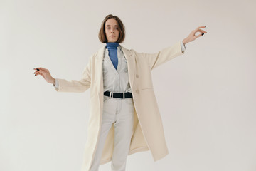 Stylish woman dancing with outstretched arms