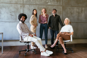 Diverse cheerful employees in spacious office