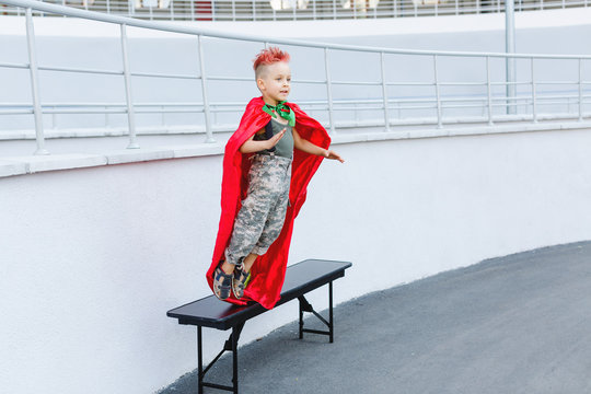 Kid superhero in a red cloak