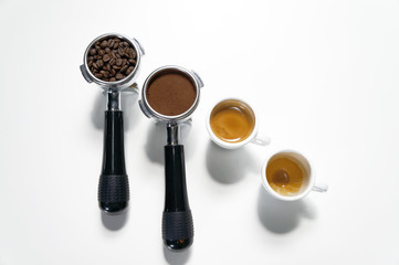 A portafilter with coffee beans, a portafilter with ground coffee, an espresso shot and an empty cup of espresso shot