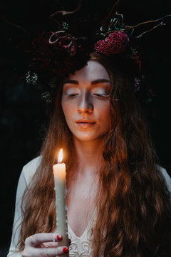 Bridal portraits of a beautiful red haired woman wearing a flower crown