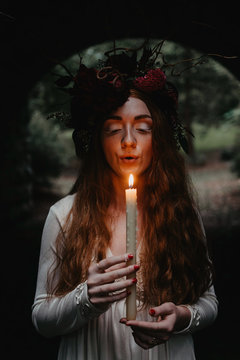Bridal portraits of a beautiful red haired woman wearing a flower crown