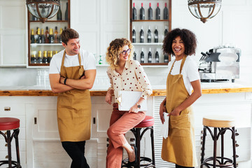 Restaurant owner and employees laughing at joke