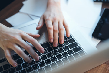 Fototapeta na wymiar Laptop keyboard female hands work freelance office model documents calculator.
