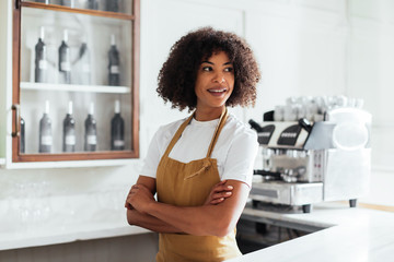 Positive black bartender behind counter