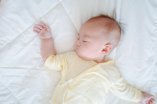 high angle view of baby sleeping on bed