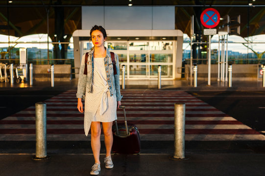 Traveller woman leaving airport terminal