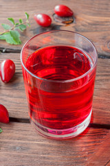 Dogwood drink in a glass on a wooden table