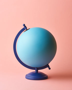 Blue Earth globe on pink background