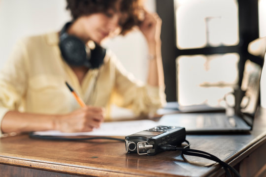 Podcaster taking notes on paper