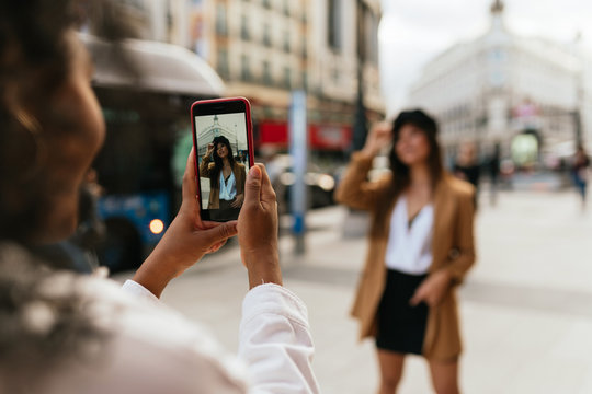 African american and chinese women taking pictures