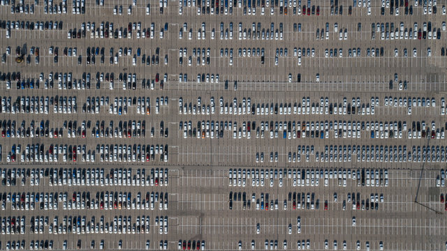 Large car parking in front of a car factory - grid filled with cars