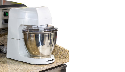 Automatic egg beater or pastry flour electric mixer machine for industrial food or bakery making on table isolated on white background with clipping path and copy space