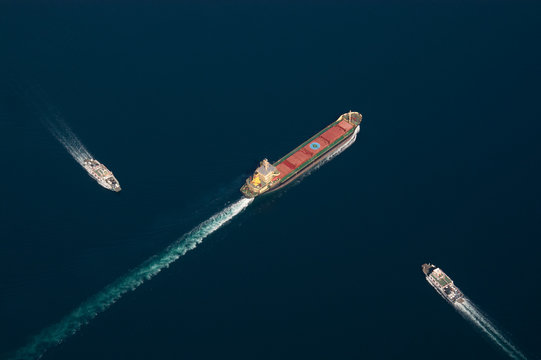 Graphic aerial shot of a freighter and two ferryboats
