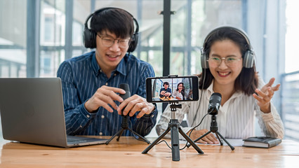 Young business people recording a podcast in a studio
