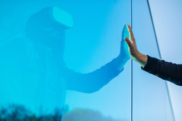 Man in VR exploring blue transparent border