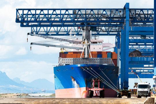 Stacked cargo containers in storage area of freight sea port terminal