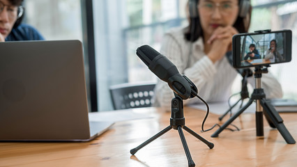Young business people recording a podcast in a studio