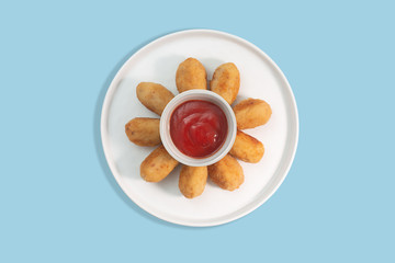 Tapas croquettes, traditional Spanish or French snack on a blue background, top view