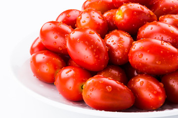 Close-up of fresh cherry tomatoes on a white dish