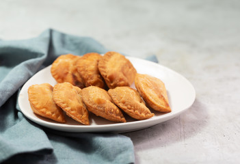 Typical Colombian empanadas usually served with spicy sauce on concrete surface