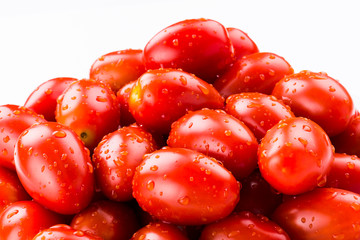 Close-up of fresh cherry tomatoes on white background